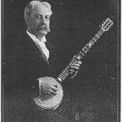 Percy French holding a banjo