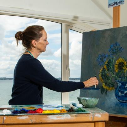 Pandora Butterfield Artist painting in her studio