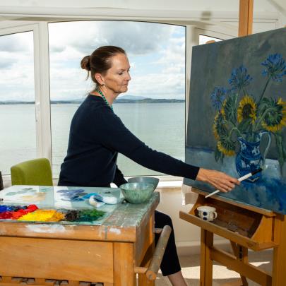 Pandora Butterfield painting in her studio