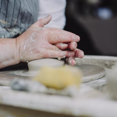 Hands throwing on a pottery wheel