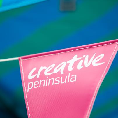 Pink bunting with the words 'creative peninsula'
