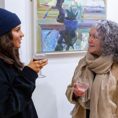 two women talking in a gallery