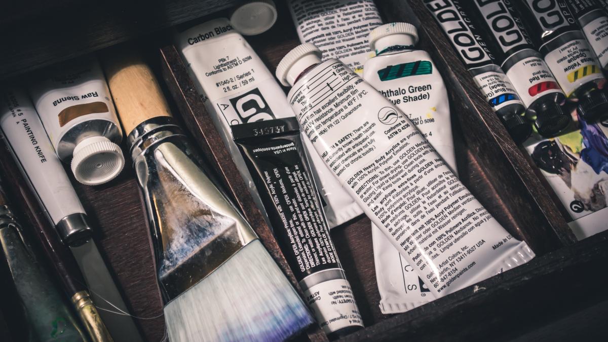 Paint tubes and brushes in a drawer