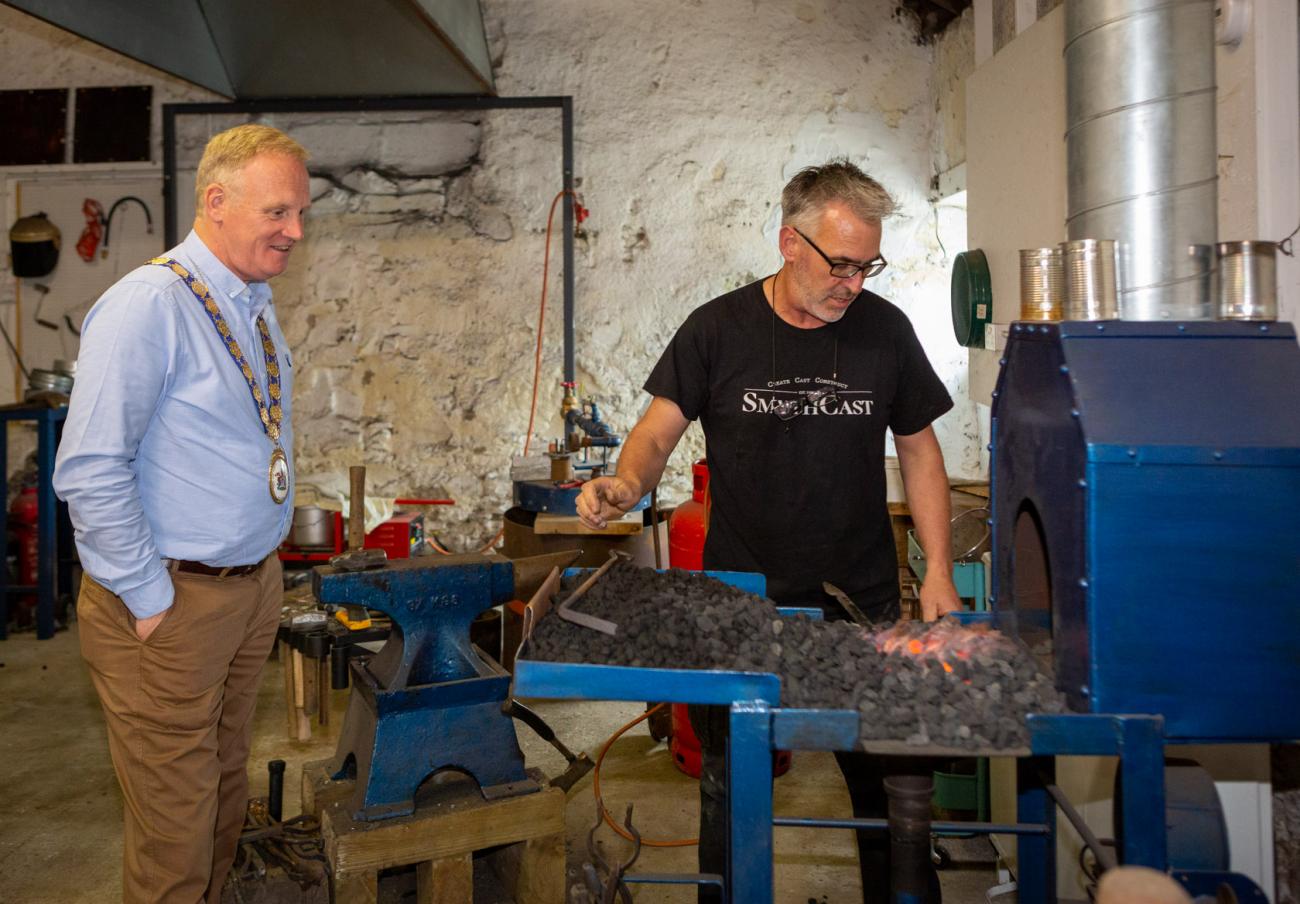 The Mayor watches sculptor Ned Jackson Smyth at work during a visit to his studio.