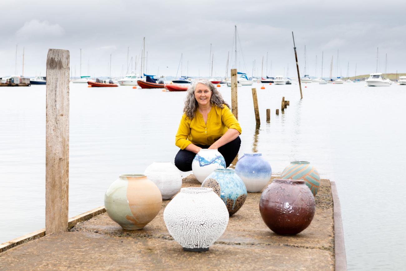 Tracey Johnston with her ceramic vessels at harbour