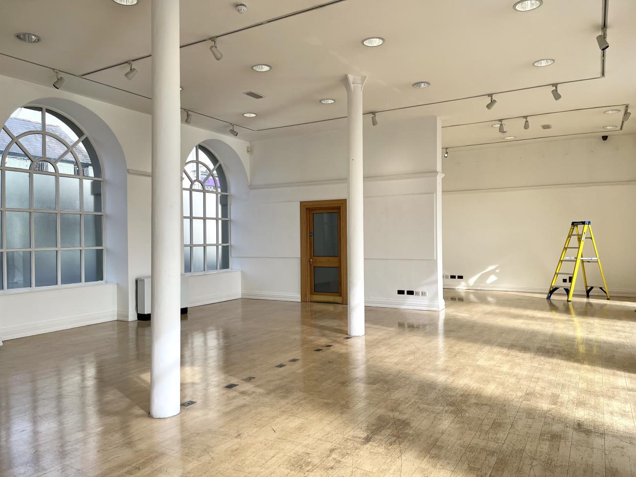 Image of an empty gallery at Ards Arts Centre with a step ladder in the far right corner